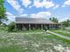 Home featuring a large, screened-in porch, perfect for enjoying the outdoors at 1850 S Lake Reedy Blvd, Frostproof, FL 33843