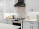 Close up of a modern kitchen featuring a backsplash, an island and stainless appliances at 1850 S Lake Reedy Blvd, Frostproof, FL 33843
