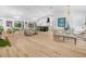 Bright, open-concept living room with hardwood floors, modern lighting, and ample seating at 1850 S Lake Reedy Blvd, Frostproof, FL 33843