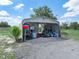 Outbuilding featuring a gravel floor, metal roof, and space for tools and machinery at 1850 S Lake Reedy Blvd, Frostproof, FL 33843