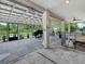 Covered patio featuring comfortable lounge area, BBQ, ceiling fans, and a secure pet enclosure with adorable dogs at 1850 S Lake Reedy Blvd, Frostproof, FL 33843