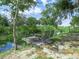 Beautiful view of a waterfront area with a dock and chairs, ideal for relaxation and enjoying nature at 1850 S Lake Reedy Blvd, Frostproof, FL 33843