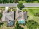Aerial view of homes with well-manicured lawns, mature trees, and screened-in pools at 1902 Southern Dunes Blvd, Haines City, FL 33844
