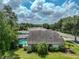 Property view featuring a screened-in pool, lush greenery, and a well-kept lawn at 1902 Southern Dunes Blvd, Haines City, FL 33844