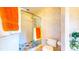 Shower with glass door, tiled walls, and decorative accents in this bright bathroom at 1902 Southern Dunes Blvd, Haines City, FL 33844