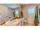 Bathroom featuring a large mirror, colorful towels and accessories, and a white door leading to a shower at 1902 Southern Dunes Blvd, Haines City, FL 33844
