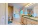 Bathroom featuring a bathtub, dual vanities, and patterned wallpaper at 1902 Southern Dunes Blvd, Haines City, FL 33844