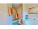 Bathroom with tiled shower, tub, and patterned wallpaper at 1902 Southern Dunes Blvd, Haines City, FL 33844