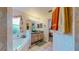 Well-lit bathroom with tub, dual sink vanity, and a large mirror at 1902 Southern Dunes Blvd, Haines City, FL 33844