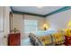 Cozy bedroom featuring a floral-patterned bedspread, window with blinds, and colorful decorative border at 1902 Southern Dunes Blvd, Haines City, FL 33844