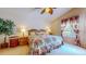 Charming bedroom featuring floral bedding, coordinating curtains, and bedside tables with lamps at 1902 Southern Dunes Blvd, Haines City, FL 33844