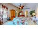 Bedroom with floral bedding, wooden dresser, and decor at 1902 Southern Dunes Blvd, Haines City, FL 33844