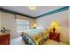 Cozy bedroom with double bed, warm lighting, and window, creating a serene and comfortable sleeping space at 1902 Southern Dunes Blvd, Haines City, FL 33844