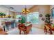Bright dining area with wooden table, chandelier, and decorative shelving, offering a cozy space at 1902 Southern Dunes Blvd, Haines City, FL 33844