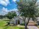 Inviting single-story home with lush landscaping, brick walkway, and two-car garage at 1902 Southern Dunes Blvd, Haines City, FL 33844