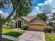 Charming single-story home with a well-manicured lawn, brick driveway, and a two-car garage at 1902 Southern Dunes Blvd, Haines City, FL 33844