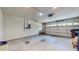 Spacious two car garage with white door, light grey floors and walls with electrical panel at 1902 Southern Dunes Blvd, Haines City, FL 33844
