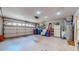 Spacious two car garage featuring painted concrete floor, water heater, and ample storage space at 1902 Southern Dunes Blvd, Haines City, FL 33844