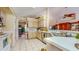 Bright kitchen with white appliances, tile floors, and ample counter space, blending functionality with a clean aesthetic at 1902 Southern Dunes Blvd, Haines City, FL 33844
