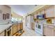 Bright kitchen features white appliances, and a window with a view of the lush outdoor landscape at 1902 Southern Dunes Blvd, Haines City, FL 33844