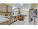 Bright open kitchen with white appliances and tile floors overlooks a sunlit dining area, blending cooking with easy entertaining at 1902 Southern Dunes Blvd, Haines City, FL 33844
