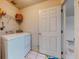 Functional laundry room with white washer and dryer, tile flooring and wire shelving at 1902 Southern Dunes Blvd, Haines City, FL 33844