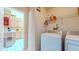 Laundry area with washer, dryer, shelving, and a view into the adjacent kitchen area at 1902 Southern Dunes Blvd, Haines City, FL 33844