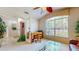Bright living area with large window, glass table, decorative plants, and comfortable seating space at 1902 Southern Dunes Blvd, Haines City, FL 33844