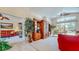 Bright living room with vaulted ceilings, large built-in shelving unit, and sliding glass doors to pool at 1902 Southern Dunes Blvd, Haines City, FL 33844