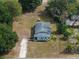 Aerial view of home showcasing its cozy layout, surrounding trees and large lot at 1949 Old Bartow Rd, Lake Wales, FL 33859
