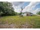 Large backyard featuring an old-fashioned wooden structure and space for customization at 1949 Old Bartow Rd, Lake Wales, FL 33859