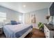 Bright bedroom with a bed dressed in blue bedding, wood floors and natural light at 1949 Old Bartow Rd, Lake Wales, FL 33859
