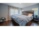Bedroom with a dark wood platform bed, wood flooring, and neutral walls, offering a cozy and comfortable retreat at 1949 Old Bartow Rd, Lake Wales, FL 33859