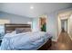 Bedroom features a dark wood platform bed, wood flooring, and view of the hall and walk-in closet at 1949 Old Bartow Rd, Lake Wales, FL 33859