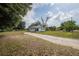 Quaint single-story home featuring a large yard and a classic, welcoming facade under a bright sky at 1949 Old Bartow Rd, Lake Wales, FL 33859