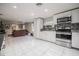 Bright, open kitchen with stainless steel appliances and modern backsplash is connected to a spacious living area at 1949 Old Bartow Rd, Lake Wales, FL 33859