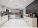 Modern kitchen with stainless steel appliances, granite counters, and a contrasting dark wood accent wall at 1949 Old Bartow Rd, Lake Wales, FL 33859