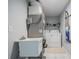 Functional laundry area featuring a utility sink, washer, dryer, and storage shelving at 1949 Old Bartow Rd, Lake Wales, FL 33859