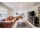 Open-concept living room with stylish furniture, tiled floors, and seamless flow to the kitchen at 1949 Old Bartow Rd, Lake Wales, FL 33859