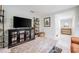 Inviting living room features stylish console with open shelving, tiled floors, and abundant natural light at 1949 Old Bartow Rd, Lake Wales, FL 33859