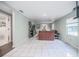 Open living room features white tile flooring and light paint, creating a bright and airy space with ample room at 1949 Old Bartow Rd, Lake Wales, FL 33859