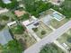 Aerial view showing a home with a pool, solar panels and accessory structure at 2100 Magnolia Ave, Haines City, FL 33844