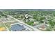 An expansive aerial view shows the property's location within a suburban landscape with fields and buildings around at 2100 Magnolia Ave, Haines City, FL 33844