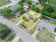 An aerial view showcases a property amidst a suburban setting, with clear views of surrounding homes and streets at 2100 Magnolia Ave, Haines City, FL 33844