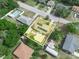 An aerial view of a home with a pool and solar panels, showcasing its location within a residential neighborhood at 2100 Magnolia Ave, Haines City, FL 33844