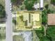 A detailed aerial view shows a property with solar panels and a patio, set among neighboring homes and lush greenery at 2100 Magnolia Ave, Haines City, FL 33844