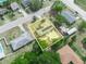 An aerial view highlights a property with solar panels and a patio space, set within a suburban neighborhood at 2100 Magnolia Ave, Haines City, FL 33844