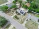 Aerial view showing a home with solar panels, a large patio area and accessory structure at 2100 Magnolia Ave, Haines City, FL 33844