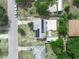 Aerial view of a home with solar panels and a patio area with checkerboard tiles at 2100 Magnolia Ave, Haines City, FL 33844