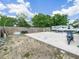 Spacious backyard featuring a parking pad, with a travel trailer and motorcycle to show the flexibility of the space at 2100 Magnolia Ave, Haines City, FL 33844